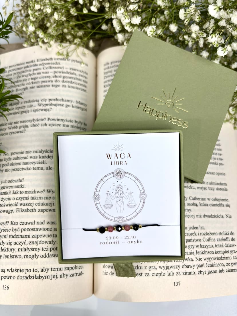 Bransoletka na czarnym sznurku nylonowym z koralikami z kamieni naturalnych: różowym rodonitem i czarnym onyksem. Opakowana w pudełko w kolorze oliwkowym ze złotym logo Happiness.